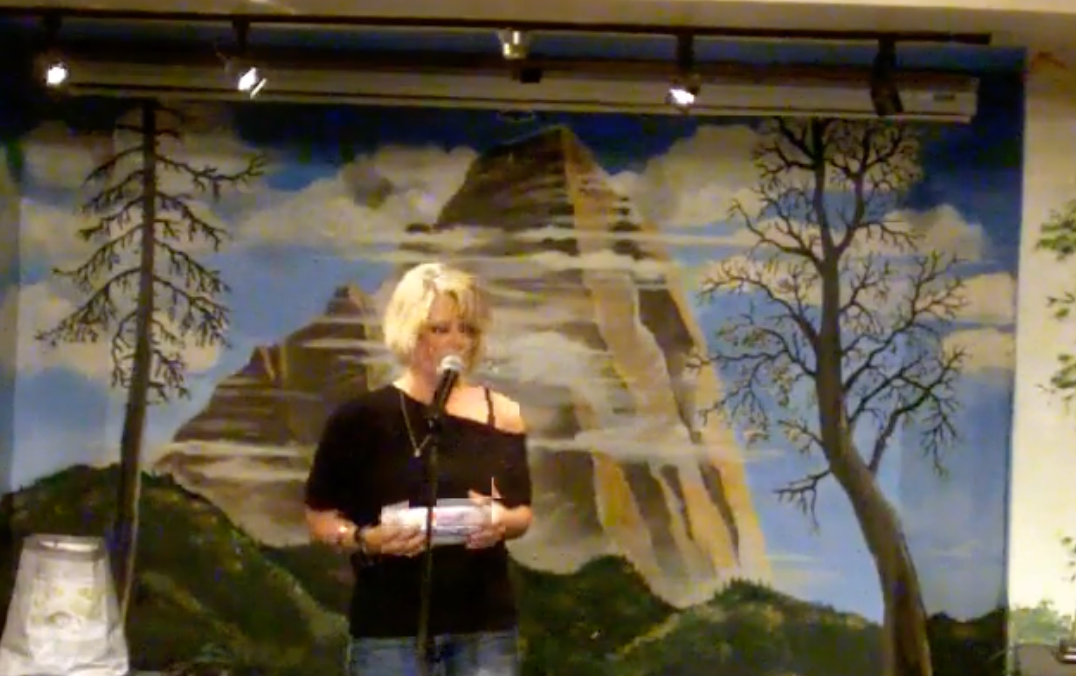 Tara Becker on stage speaking to an audience